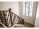 Staircase with wooden railing and glass block window at 1327 E Judi Dr, Casa Grande, AZ 85122
