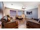 Spacious living room with leather furniture and large windows at 1327 E Judi Dr, Casa Grande, AZ 85122