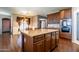 Island kitchen with dark wood cabinets and granite countertops at 1327 E Judi Dr, Casa Grande, AZ 85122