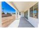 Covered patio with sliding glass doors and backyard access at 7583 W Gelding Dr, Peoria, AZ 85381