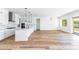 Modern kitchen with white cabinets, large island, and stainless steel appliances at 7583 W Gelding Dr, Peoria, AZ 85381