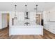 Modern kitchen with white cabinets and island at 7583 W Gelding Dr, Peoria, AZ 85381