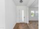 Light and airy entryway with herringbone floors and a white door at 7583 W Gelding Dr, Peoria, AZ 85381