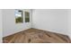Spacious bedroom with herringbone floors and two large windows at 7583 W Gelding Dr, Peoria, AZ 85381