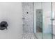 Modern shower with patterned tile and glass enclosure at 7583 W Gelding Dr, Peoria, AZ 85381