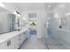 Modern bathroom with double vanity, large shower, and stylish fixtures at 7583 W Gelding Dr, Peoria, AZ 85381
