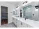 Modern bathroom with double vanity, walk-in shower, and matte black fixtures at 7583 W Gelding Dr, Peoria, AZ 85381