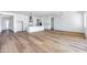 Spacious kitchen with white cabinets, hardwood floors and an island at 7583 W Gelding Dr, Peoria, AZ 85381