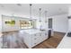 Modern kitchen island with white cabinets and stainless steel appliances at 7583 W Gelding Dr, Peoria, AZ 85381