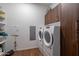 Modern laundry room with washer, dryer and storage cabinets at 7180 E Kierland Blvd # 1115, Scottsdale, AZ 85254