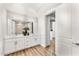 Double vanity bathroom with modern white cabinets and wood floors at 3131 N Central Ave # 6012, Phoenix, AZ 85012