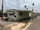 Mobile home with carport and palm trees at 7300 N 51St Ave # 208, Glendale, AZ 85301