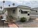 Mobile home with carport and brick walkway at 7300 N 51St Ave # 208, Glendale, AZ 85301