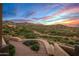 Landscaped pathway with mountain views and sunset at 11519 E Blue Wash Rd, Cave Creek, AZ 85331