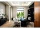 Home office with large window, built-in shelving, and modern desk at 6554 N 40Th Pl, Paradise Valley, AZ 85253