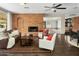 Living room featuring a brick fireplace and hardwood floors at 7120 N Clearwater Pkwy, Paradise Valley, AZ 85253