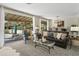 Living area with leather couch, glass-top coffee table and pool view at 7120 N Clearwater Pkwy, Paradise Valley, AZ 85253