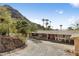 House exterior with a red door and mountain views from the driveway at 7120 N Clearwater Pkwy, Paradise Valley, AZ 85253