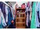 Closet with wooden shelving and hanging clothes at 2 E Muriel Dr, Phoenix, AZ 85022