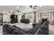 Open living room featuring a sectional sofa and a large TV at 2 E Muriel Dr, Phoenix, AZ 85022