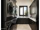 Laundry room with dark cabinetry and high-end appliances at 6112 E Quartz Mountain Rd, Paradise Valley, AZ 85253