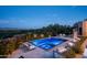 Modern pool and spa with mountain views at night at 6112 E Quartz Mountain Rd, Paradise Valley, AZ 85253