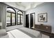Spacious bedroom with arched windows and ensuite bathroom at 6112 E Quartz Mountain Rd, Paradise Valley, AZ 85253