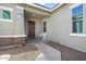 Inviting front porch with a bench, stone accents, and a brown door at 21088 E Arroyo Verde Dr, Queen Creek, AZ 85142