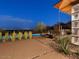 Night view of backyard pool, patio, and fire pit with city lights at 4796 E Charles Dr, Paradise Valley, AZ 85253