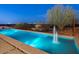 Long rectangular pool with fountain and city views at 4796 E Charles Dr, Paradise Valley, AZ 85253