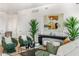 Spacious living room featuring stylish green armchairs and a coffee table at 3131 N Central Ave # 3015, Phoenix, AZ 85012