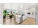 Open concept kitchen with island and living area view, hardwood floors, and white cabinets at 3131 N Central Ave # 3012, Phoenix, AZ 85012