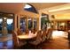 Elegant dining room featuring a large table and chairs, hardwood floors, and large windows at 15 Biltmore Estates Dr, Phoenix, AZ 85016