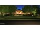Elegant home exterior with manicured lawn and nighttime lighting at 15 Biltmore Estates Dr, Phoenix, AZ 85016