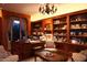Home office with built-in bookshelves and a large desk, ideal for working from home at 15 Biltmore Estates Dr, Phoenix, AZ 85016