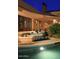Luxury pool and fountain at night, surrounded by landscaping at 15 Biltmore Estates Dr, Phoenix, AZ 85016