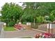Gated community entrance with lush landscaping and brick pavement at 15 Biltmore Estates Dr, Phoenix, AZ 85016