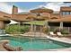 Inviting pool area with spacious deck and shade structures at 15 Biltmore Estates Dr, Phoenix, AZ 85016