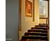 Elegant wooden staircase with detailed runner and artwork at 15 Biltmore Estates Dr, Phoenix, AZ 85016