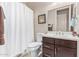 Clean bathroom with dark vanity and shower/tub combo at 42833 W Mallard Rd, Maricopa, AZ 85138