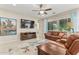 Spacious living room featuring a large TV, comfortable seating, and a view to the kitchen at 42833 W Mallard Rd, Maricopa, AZ 85138