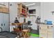 Workshop area with workbench, storage shelves, and TV at 42833 W Mallard Rd, Maricopa, AZ 85138