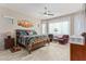 Main bedroom with a king-size bed, ceiling fan, and plenty of natural light at 42833 W Mallard Rd, Maricopa, AZ 85138