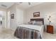 Bright bedroom with access to a bathroom and tile flooring at 42833 W Mallard Rd, Maricopa, AZ 85138