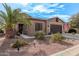 Single-story home with a two-car garage and landscaped yard at 42833 W Mallard Rd, Maricopa, AZ 85138