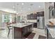 Modern kitchen with dark cabinetry, granite counters, and stainless steel appliances at 42833 W Mallard Rd, Maricopa, AZ 85138
