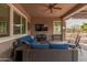 Covered patio with seating area and large TV at 42833 W Mallard Rd, Maricopa, AZ 85138