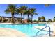 Community pool with surrounding patio and lounge chairs at 42833 W Mallard Rd, Maricopa, AZ 85138