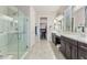 Double vanity bathroom with a large walk-in shower at 42833 W Mallard Rd, Maricopa, AZ 85138