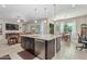 Open concept kitchen with large island, granite countertops, and stainless steel appliances at 42833 W Mallard Rd, Maricopa, AZ 85138